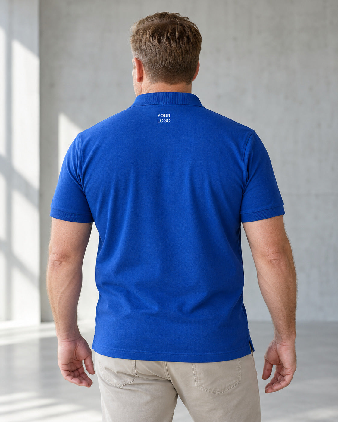 Model showing a blue polo shirt from the back.